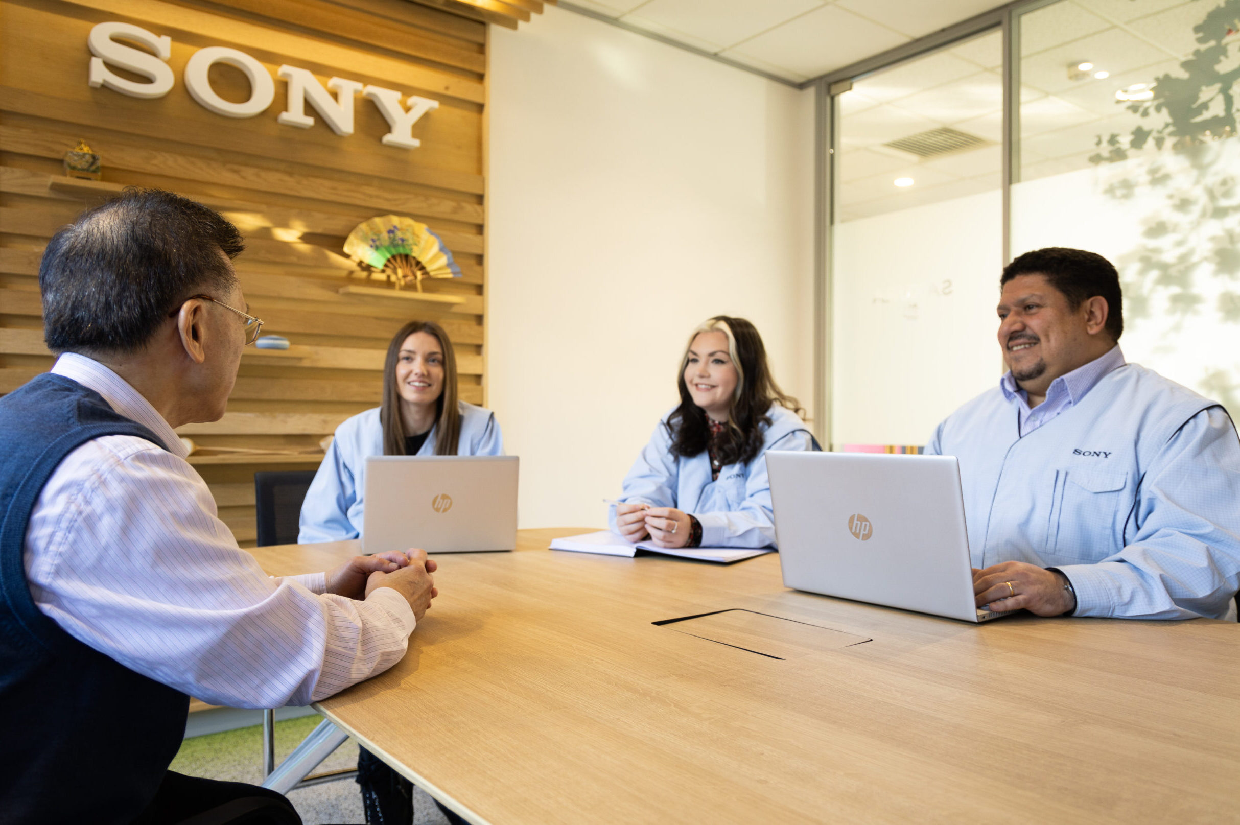 a photo of 4 people having a meeting